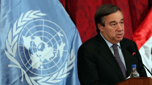 António Guterres with the U.N. flag behind him