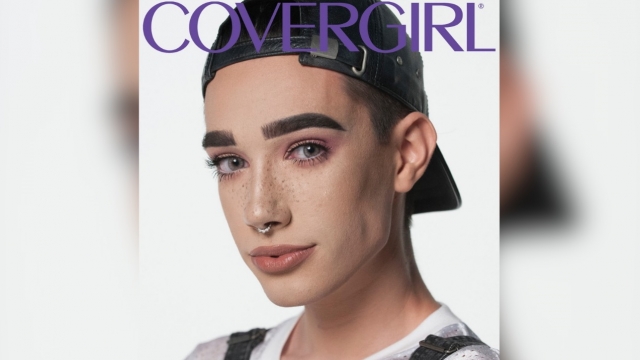 James Charles appears with the CoverGirl logo. He wears makeup, a backwards baseball cap, overalls and a shirt.