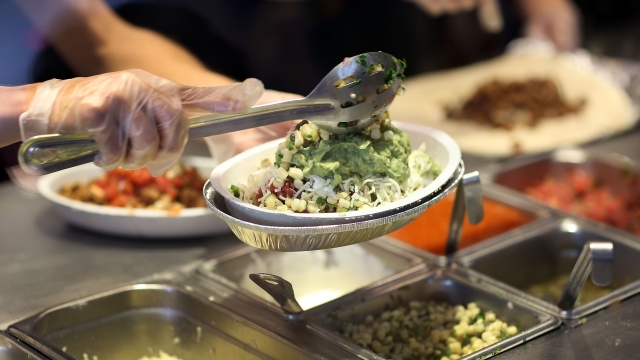 A worker serves food at a Chipotle restaurant.