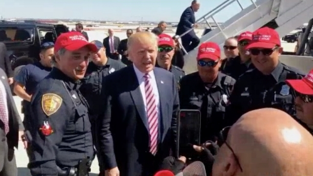 Trump poses with San Antonio police officers.