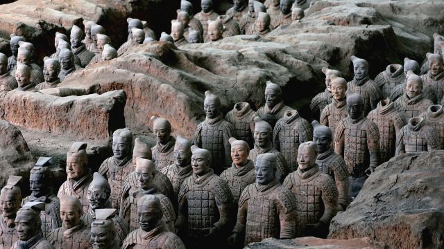 Terracotta warriors in a pit.