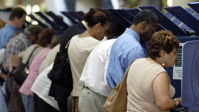 Hispanic voters go to the polls for early voting at the Miami-Dade Government Center.