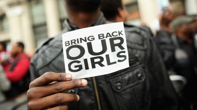 A man holds a sign that reads 'Bring back our girls' during a protest