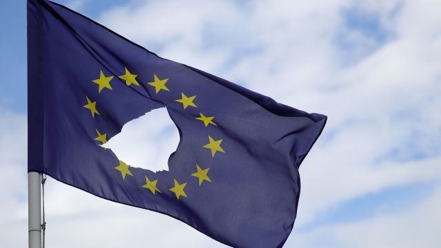 A European Union flag with a hole in it.