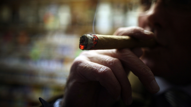 Cigar lover Paul Clarke samples a Havana cigar in Turmeau's.