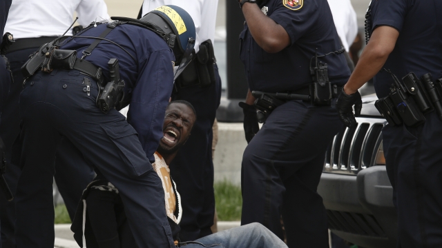 Police officers arrest a man in Baltimore.