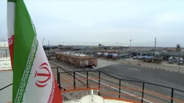 The Iranian flag flies over an oil rig.