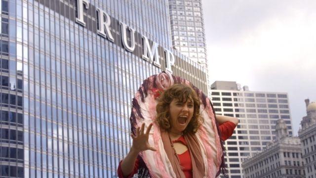 A #GOPHandsOffMe protestor dressed in a vagina costume poses in front of Trump Tower in Chicago.