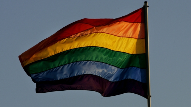 A Rainbow flag flies.