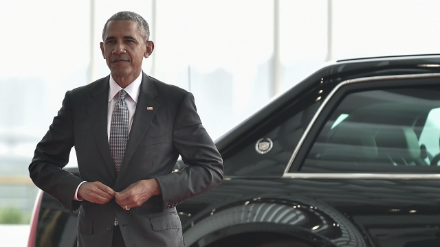 President Barack Obama exits his presidential limo.