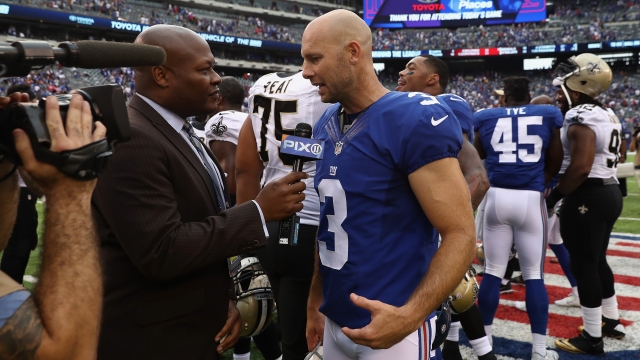 Giants kicker Josh Brown speaks to a reporter after a game