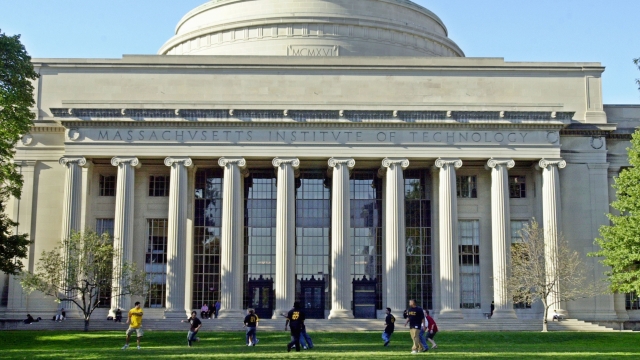 Massachusetts Institute of Technology students play football outside the Maclaurin building.