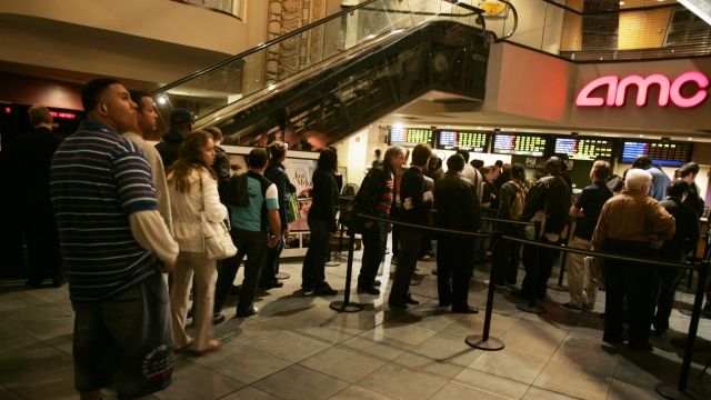 Fans wait in line to buy remaining tickets to popular movies at the AMC Theaters.