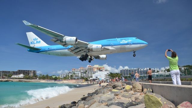 A KLM Boeing 747 descending onto a runway at St. Maarten's airport.