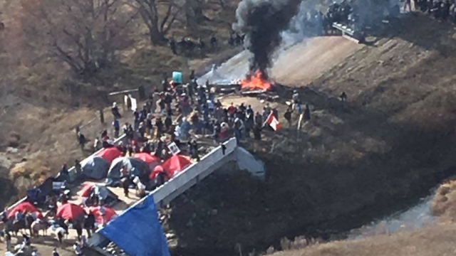 Protesters face police at a Dakota Access Pipeline construction site.