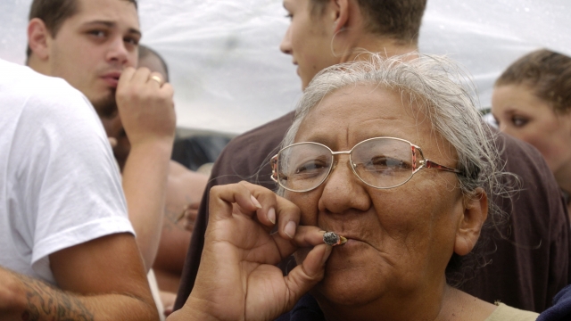 An older woman smokes a marijuana joint at Hempfest on August 21, 2004 in Seattle, Washington.