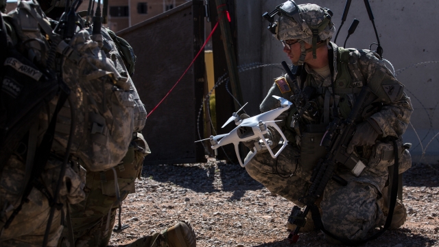 U.S. soldiers assigned to 1st Battalion, 6th Infantry Regiment, retrieve an enemy drone while conducting an assault.