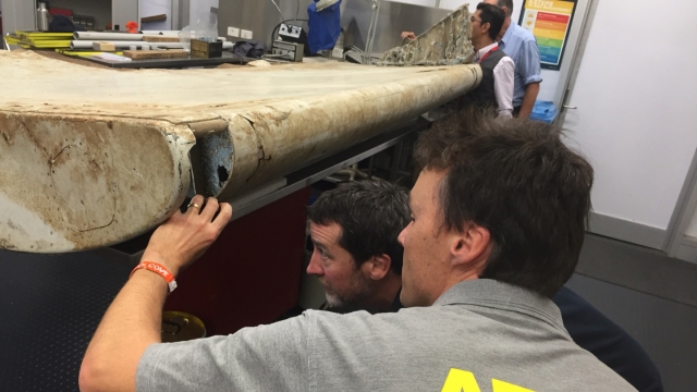 ATSB investigators analyze a wing flap from the missing MH370 aircraft.