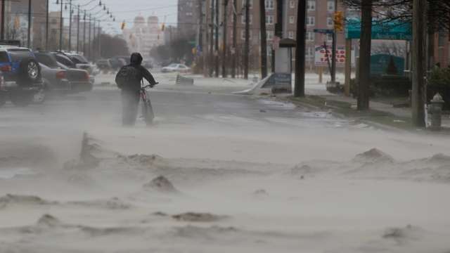 A person walks down a flooded street New York City due to Hurricane Sandy.