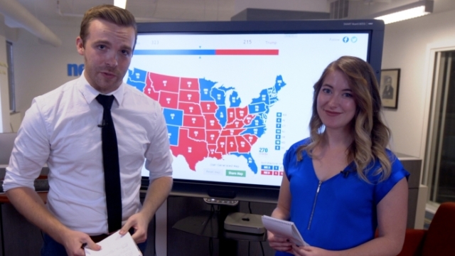 Newsy's Zach Toombs And Kate Grumke Stand In Front Of The Electoral Map