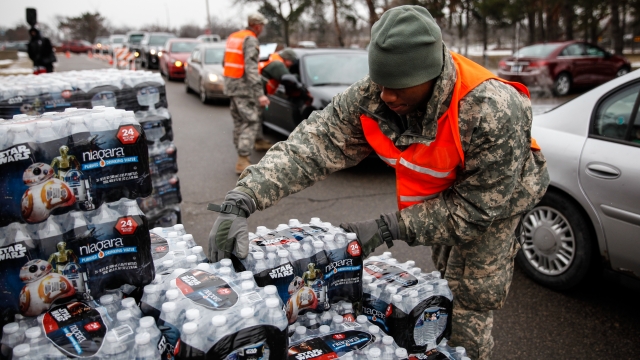 Army National Guardsman unloading bottled water