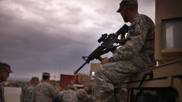Soldiers take inventory of weapons before a mission at Bagram Air Base.