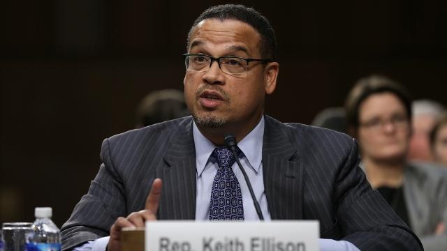 Rep. Keith Ellison sits at a microphone.