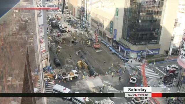 Workers fill a sinkhole in Japan.