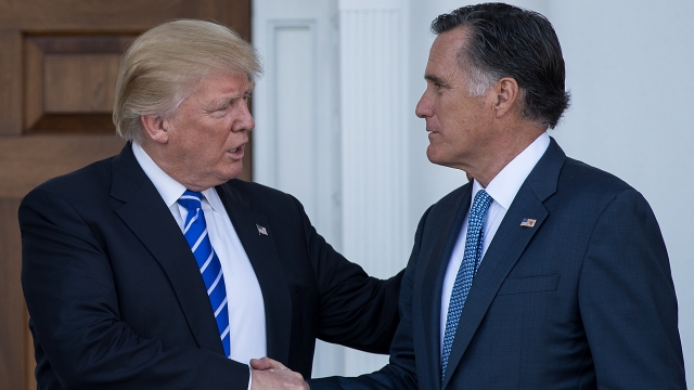 Donald Trump and Mitt Romney shaking hands