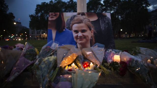 Flowers surround a picture of Jo Cox during a vigil.