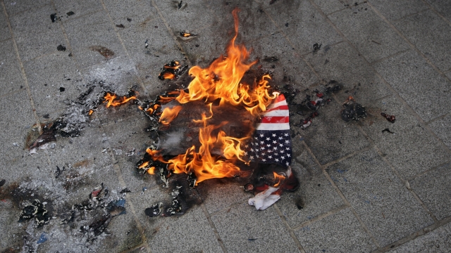 An American flag burns.