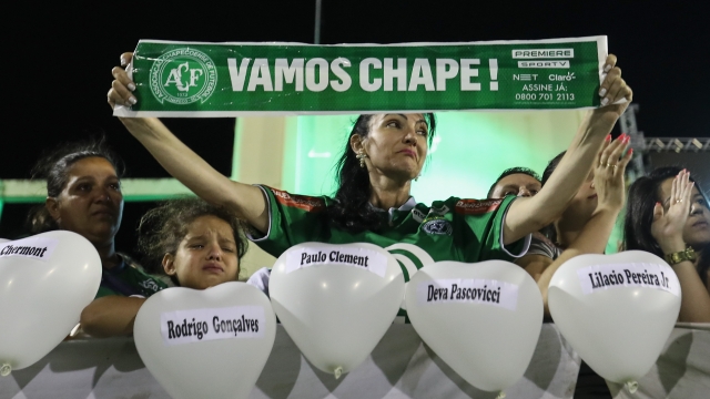 Fans cry while paying tribute to the players of Brazilian team Chapecoense.