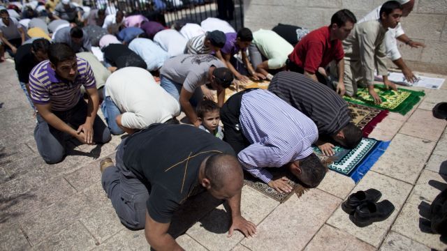 Palestinian worshippers pray at a mosque