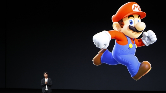 Video game designer Shigeru Miyamoto and game character Mario