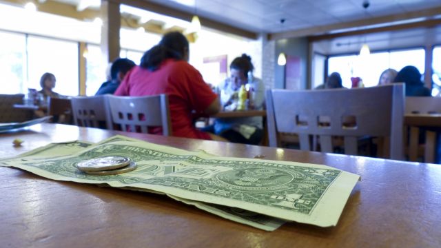 A few dollars left on a restaurant table