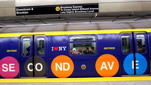 Commuters take the downtown Q train at the 72nd St. station on New York's new Second Avenue subway line.