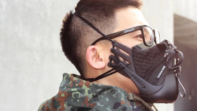 Designer Zhijun Wang wearing a smog mask he made from running shoes.
