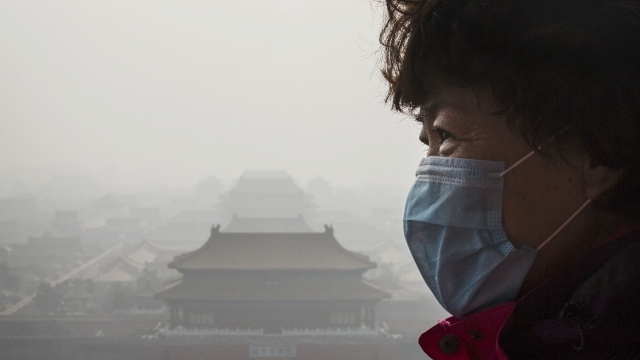 Chinese woman wearing mask in heavy smog
