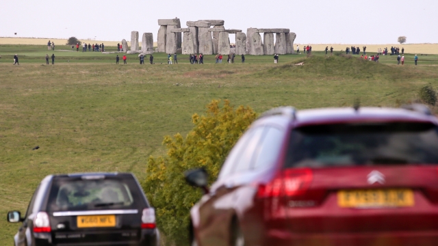 Cars drive on a busy road near Stonehenge.