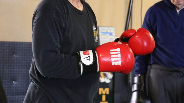 A member of the boxing class prepares to punch the bag