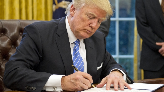 Donald Trump signs a memorandum.