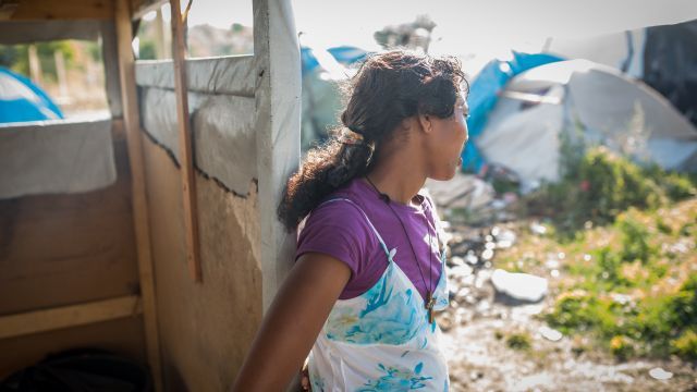 An Eritrean woman stands in a refugee camp