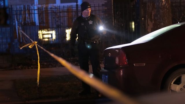 Police investigate the scene of a shooting in Chicago.