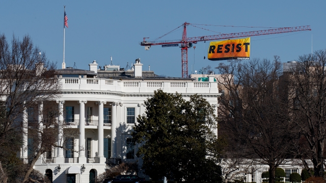 "Resist" banner hangs over the White House.