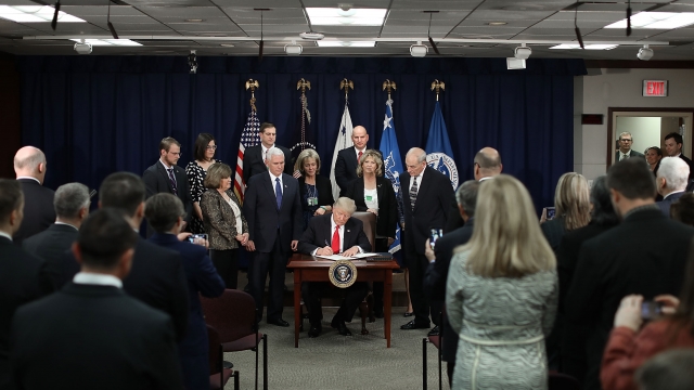 President Donald Trump signs executive orders.