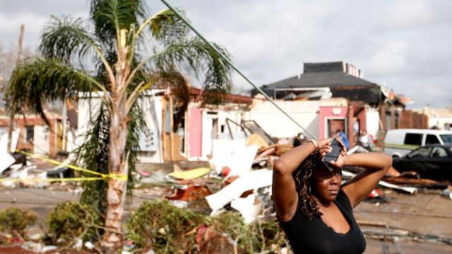 A woman looks at the wreckage caused by a tornado in New Orleans.