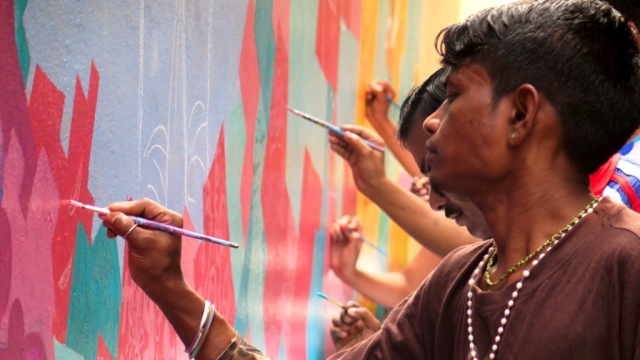 Local residents painting a mural in India