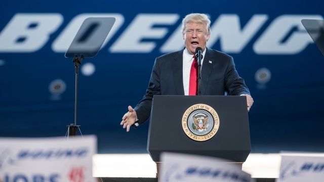 President Donald Trump addresses a crowd during the debut event for the Dreamliner 787-10