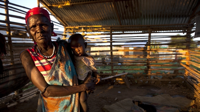 A woman holds her grandson in South Sudan.
