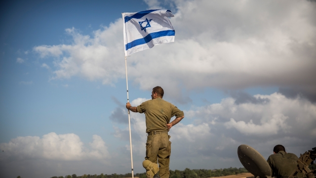 An Israeli soldier with a flag